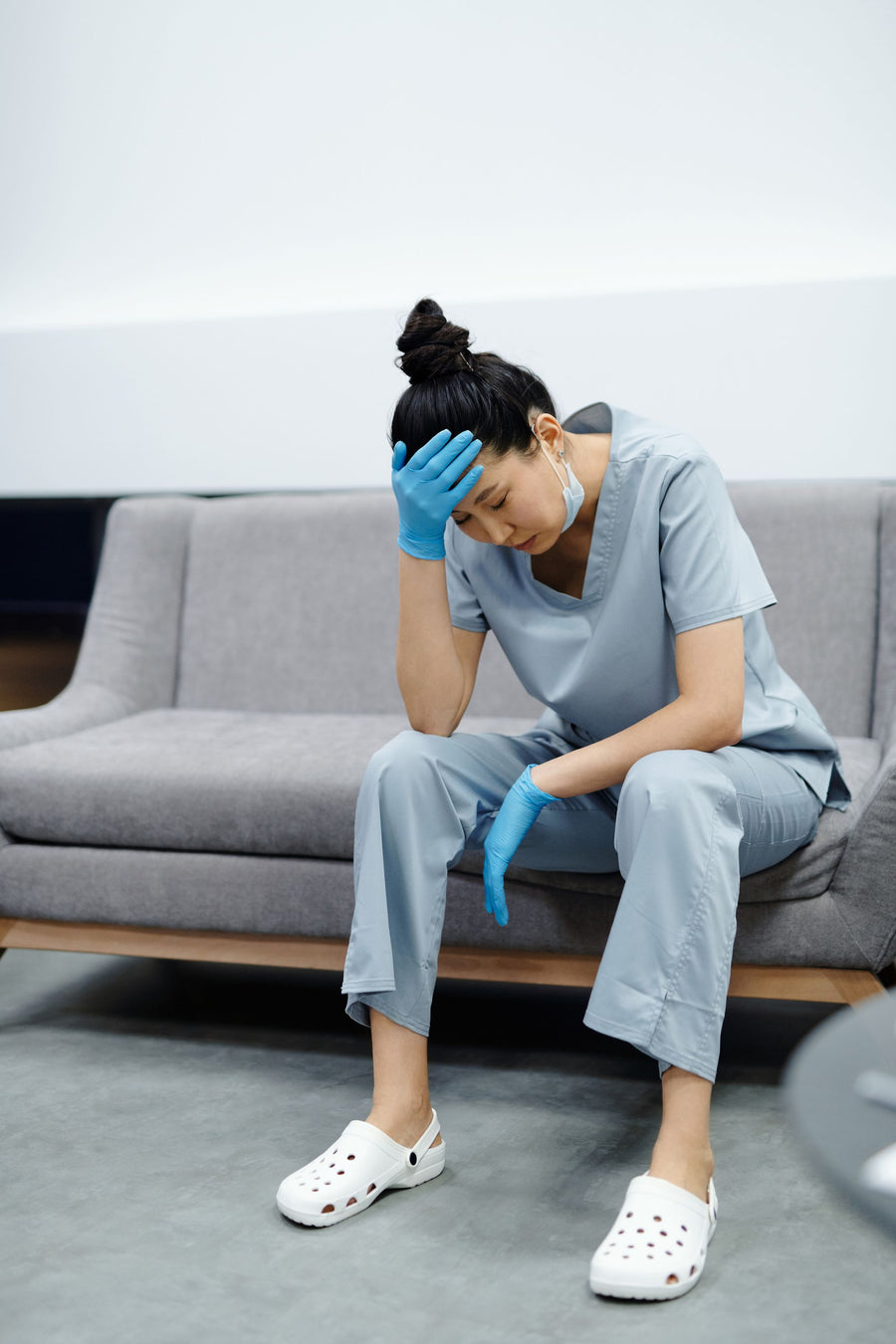 Tired nurse sitting down after a shift on her feet